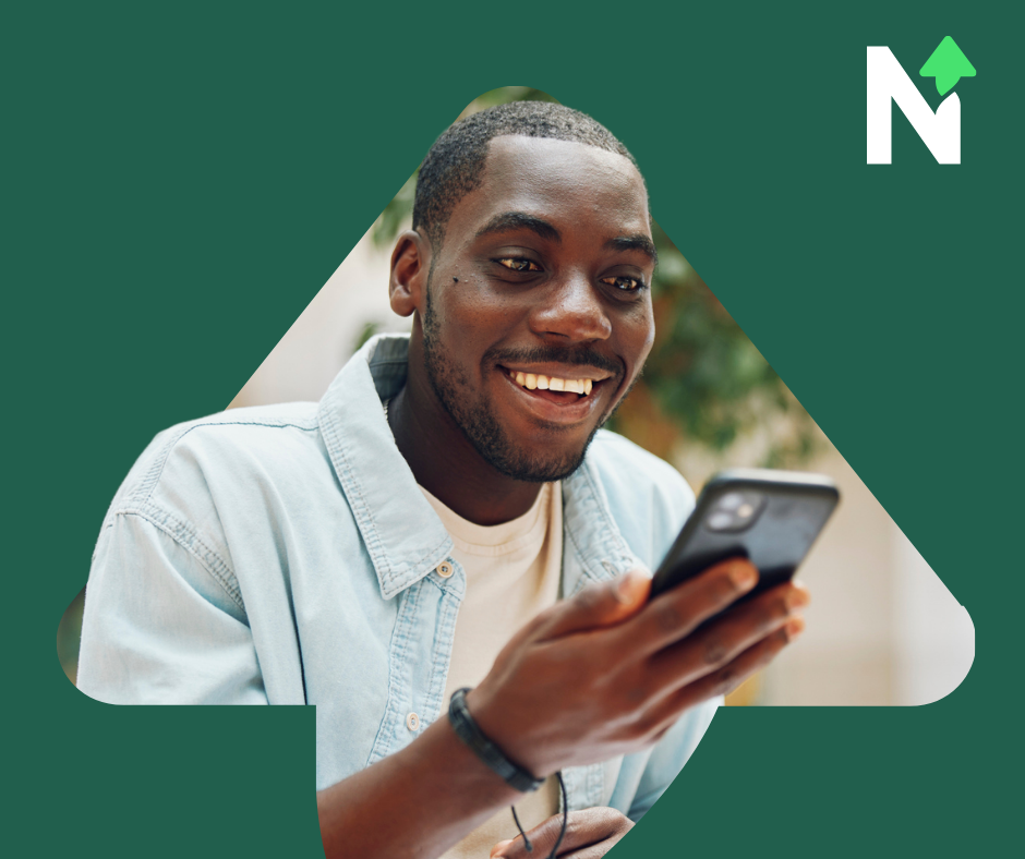 a man smiling looking at his mobile phone